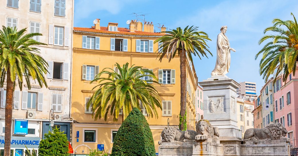 The monument of Napoleon in Roman garb, surrounded by stone lions and ornamental garden, located in Place Foch, Ajaccio